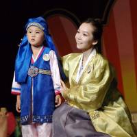A North Korean woman and her son take part in the 14th National Korean Dress Show in Pyongyang, in a photo released Wednesday. Rethinking U.S. policy of 'strategic patience' with North Korea