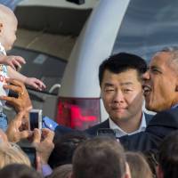 U.S. President Barack Obama tickles a baby on Sunday at New York's John F. Kennedy International Airport. Obama aims to define his global leadership in final U.N. speech