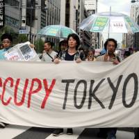 Protesters march through the Kasumigaseki district, the location of most government ministry offices, during an Occupy Tokyo demonstration on Oct. 15, 2011. Five years later, influence of Occupy Wall Street called widespread