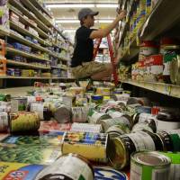 Max Horn helps to clean up the damage in White's Foodliner after an early morning earthquake in Pawnee, Oklahoma, on Saturday. Strong Oklahoma temblor prompts just fraction of state's wastewater wells to close