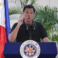 Philippines President Rodrigo Duterte delivers a speech at the Davao international airport terminal building early on Friday, shortly after arriving from an official visit to Vietnam. Duterte drew a parallel with his deadly crime war and Hitler's massacre of Jews. Duterte likens deadly war on drugs to Hitler's slaughter of Jews