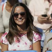 Pippa Middleton, left, the sister of Kate, the Duchess of Cambridge, watches the quarterfinal tennis match between Canada's Milos Raonic and France's Gilles Simon at the Queen's Championships in London on June 19, 2015. Man trying to sell hacked photos of Kate Middleton's sister is arrested
