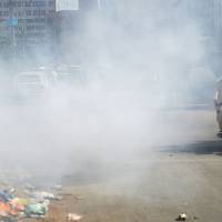 A Pakistani motorcyclist covers his face as he rides past smoke along a street in Karachi on Tuesday. Nine out of 10 people globally are breathing poor quality air, the World Health Organization said Tuesday, calling for dramatic action against pollution that is blamed for more than 6 million deaths a year. Excessive air pollution affects 92% of people worldwide: WHO