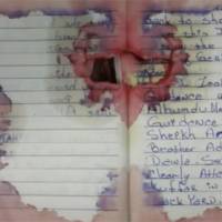 This image released by House Homeland Security Committee shows pages in a notebook recovered in the arrest of Ahmad Khan Rahami. Federal court complaints filed Tuesday gave a chilling glimpse into what authorities say motivated the Afghan-born U.S. citizen to set off explosives last weekend in New York City and New Jersey, including a bomb that injured 31 people in Manhattan. The complaints said in his bloodied journal, damaged by shots from his gun battle with police, he fumed that the U.S. government was slaughtering Muslim holy warriors and alluded to plans for revenge. Accused NYC bomber's wife returns; lawyer seeks to meet suspect