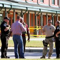 Anderson County sheriff's deputies and investigators gather outside of Townville Elementary School after a shooting in Townville, South Carolina, Wednesday. Boy, 6, 'fighting for his life' after South Carolina school shooting: fire chief