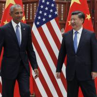 U.S. President Barack Obama and Chinese President Xi Jinping look at each other after shaking hands before a bilateral meeting at West Lake State Guest House in Hangzhou in eastern China's Zhejiang province, on Saturday. Xi defiant as Obama presses Chinese leader on South China Sea