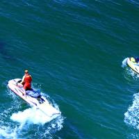 Life savers chase a shark off Lighthouse Beach in Ballina, New South Wales, Australia, following a shark attack that injured a 17-year-old surfer on Monday. Teen surfer in stable condition after being bitten by shark north of Sydney