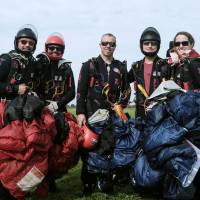 In this Tuesday photo, U.S. team SDC Core (from left) Dusty Hanks, Kai Kai Buchholz, Jake Jenson, Jason Russell and Stephanie Strange pose after landing during a round at Skydive Chicago in Ottawa, Illinois. The Chicago-based team won the vertical formation skydiving gold medal at the World Parachuting Championships Tuesday. U.S. team aces France, Canada to bag gold in vertical formation skydiving championship