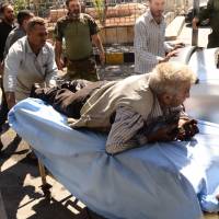 A wounded Syrian man is rushed into a hospital after he was hit by mortar shells that targeted Aleppo's government controlled Aziziyah and Suleimaniyah neighbourhoods on Sept. 28, 2016. Two biggest hospitals in rebel-held Aleppo bombed