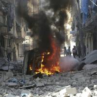 Syrians inspect damaged buildings after airstrikes by government helicopters on the rebel-held Aleppo neighborhood of Mashhad on Tuesday. A year of bombing in Syria stirs little debate among Russians