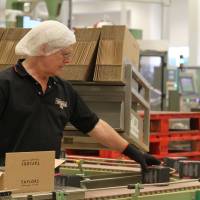 An employee packs boxes of tea on the production line at Taylors of Harrogate's tea packaging facilities in Harrogate, northern England, at the end of August. British habit of drinking tea catching on among Chinese