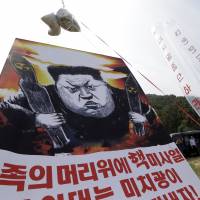 North Korean defectors prepare to release balloons carrying leaflets and a banner denouncing North Korean leader Kim Jong Un after the North's latest nuclear test, in Paju, near the border with South Korea, on Sept. 15. U.S. to deploy anti-missile THAAD system to South Korea 'as soon as possible'