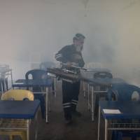 A pest control worker fumigates an examination hall of a school on the eve of the annual national Primary School Evaluation Test in Kuala Lumpur on Sept. 4. Bangkok says it now has 21 confirmed locally transmitted Zika cases. Bangkok reports 21 new locally transmitted Zika cases