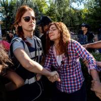 Turkish police arrest a teacher during a demonstration to protest the suspension of teachers for suspected links with militants, on Saturday in Diyarbakir. Turkey. Kurds blamed as bomb on tracks detonates in Turkey; driver wounded