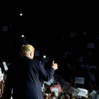 Republican presidential nominee Donald Trump arrives onstage for a rally in Roanoke, Virginia, on Saturday. Trump's outsider status in Washington, D.C., shields him from scrutiny