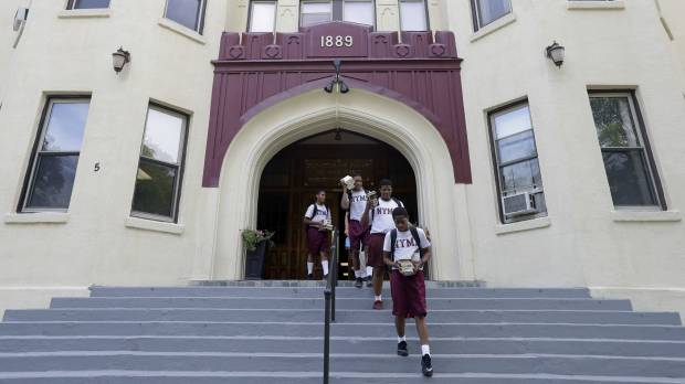 Cadets walk out of the academic building at the New York Military Academy in Cornwall-on-Hudson, New York. Trump's old military prep school looks overseas for renewal, gets Chinese backing