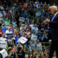 Republican presidential nominee Donald Trump takes the stage for a rally with supporters in Kenansville, North Carolina, Tuesday. Trump skips swing-state cities, makes pitch to whites in immigrant-dependent rural North Carolina