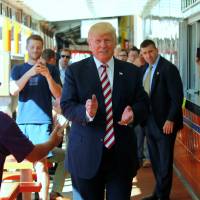 Republican presidential nominee Donald Trump makes a stop at Geno's Steaks cheesesteak restaurant in Philadelphia Thursday. Trump urges racial unity amid 'national crisis' but then also hits drug use, pushes 'stop and frisk'