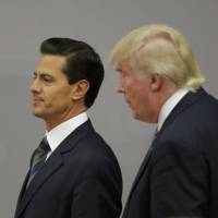 U.S. Republican presidential nominee Donald Trump and Mexican President Enrique Pena Nieto walk out after finishing a press conference at the Los Pinos residence in Mexico City Wednesday. Trump talks about the wall with Mexican President Pena Nieto, but not the financing