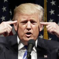 Republican presidential candidate Donald Trump speaks at a rally Wednesday in Council Bluffs, Iowa. Trump won't change debate tack, faces new tax pressure