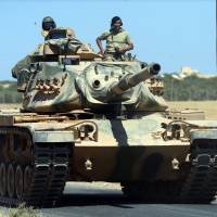 A Turkish tank heads to the Syrian border, in Karkamis, Turkey, Friday. Turkish troops and allied Syrian rebels expelled the Islamic State group from the last strip of territory it controlled along the Syrian-Turkish border on Sunday, effectively sealing the extremists' self-styled caliphate off from the outside world, Turkey's state-run news agency reported. Turkey reports ousting Islamic State from Syria border area, bombs Kurd positions