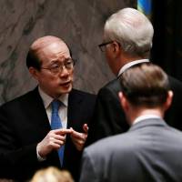 Russian Ambassador to the United Nations Vitaly Churkin speaks with Chinese Permanent Representative to the United Nations Liu Jieyi inside before a United Nations Security Council vote to adopt a resolution on the Comprehensive Nuclear-Test-Ban Treaty at U.N. headquarters in New York on Friday. U.N. Security Council backs nuke test ban implementation