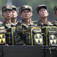 North Korean soldiers carry packs marked with a radiation symbol, possibly to denote tactical nuclear bombs, during a parade on the 60th anniversary of the Korean War armistice in Pyongyang in July 2013. U.S., China to step up coordination on North Korea