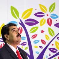 Venezuela's President Nicolas Maduro waits during the welcoming ceremony of the 17th Non-Aligned Summit in Porlamar on Saturday. Non-Aligned summit's turnout low due to Venezuelan crisis