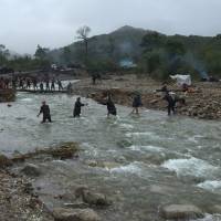 A Sept. 8, 2016, file photo shows mobilized villagers attempting to repair roads from Chongjing to Musan and Yonsa counties in North Hamyong province. North Korea floods wipe out crops, triggering crisis as winter approaches: WFP