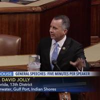 In this frame grab from video provided by C-SPAN, Rep. David Jolly holds a container of mosquitoes while speaking of the House floor on Capitol Hill in Washington, Wednesday. The politics of Zika are garbage right now, the Florida lawmaker said in a short, angry speech condemning Congress for failing to pass legislation providing $1.1 billion to combat the mosquito-borne virus. Senator brings jar of mosquitoes as Congress weighs Zika funding deal