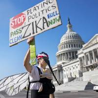 A man wearing a homemade mosquito costume, who asked not to be identified, protests the lack of Congressional approval to fund a federal response to the Zika virus, on Capitol Hill in Washington Wednesday. Republicans are proposing to allow Zika-fighting money for Planned Parenthood-affiliated clinics as negotiators try to reach a deal and adjourn Congress for the fall campaign, congressional aides said Thursday. GOP ranks in Congress look to drop Planned Parenthood ploy, fund Zika fight: aides