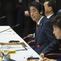 Prime Minister Shinzo Abe attends the ASEAN Plus Three Summit in Vientiane on Wednesday. Abe tells Asian leaders of 'serious concern' with China posturing in South China Sea