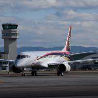 A Mitsubishi Regional Jet touches down at Nagoya Airport in Toyoyama, Aichi Prefecture, following its maiden flight last November. If it passes testing, it will become Japan's first domestically produced commercial plane since 1974. New MRJ hiccups revive manufacturing industry's jitters