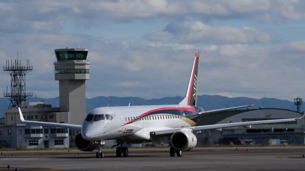 A Mitsubishi Regional Jet touches down at Nagoya Airport in Toyoyama, Aichi Prefecture, following its maiden flight last November. If it passes testing, it will become Japan's first domestically produced commercial plane since 1974. New MRJ hiccups revive manufacturing industry's jitters