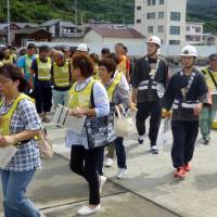 Local residents gather Sunday at Misaki port near the Ikata nuclear power plant in Ehime Prefecture during an evacuation drill. Residents take part in evacuation drill near Ikata nuclear plant