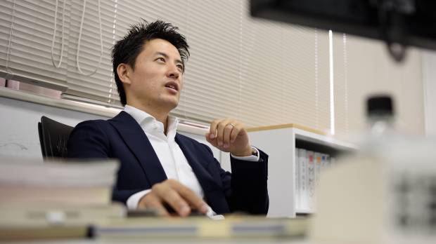 Takahiro Kusakari, chief investment officer of Sawakami Asset Management Inc., sits in front of a computer at the company's office in Tokyo on Sept. 2. From bit actor ‘bum’ to managing $2.7 billion Japanese fund