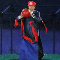 Prime Minister Shinzo Abe, dressed up as Super Mario, makes an appearance during the closing ceremony of the Rio Olympics on Aug. 21. ‘Abe-Mario’ segment costs Nintendo nothing but gambit still pays off