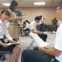 Interns conduct mock interviews as probation officers on Aug. 9 in Tokyo’s Kasumigaseki district. Family court probation officer internships give students insight into little-known career
