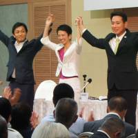 Candidates for the Democratic Party presidential race (from left) Yuichiro Tamaki, Renho and Seiji Maehara, raise their arms during a discussion session held in the city of Shizuoka last Thursday. Renho the top choice among DP regional execs in party's leadership race
