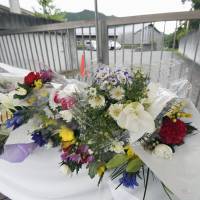 Flowers are seen at the gate to the Tsukui Yamayuri-en care facility in Sagamihara, Kanagawa Prefecture, on Wednesday. Sagamihara massacre suspect's mental health treatment insufficient: report