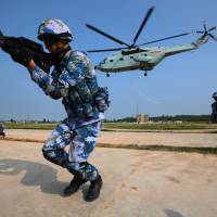 Chinese marines take part in a joint naval drill with Russian forces in Zhanjiang, south China's Guangdong Province, on Sept. 13. China warns Japan against 'playing with fire' in South China Sea