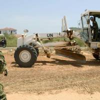 Ground Self-Defense Force personnel work on road construction in South Sudan as part of U.N. peacekeeping operations in July 2015. Japan to decide by end of month on expanded SDF peacekeeping protection role