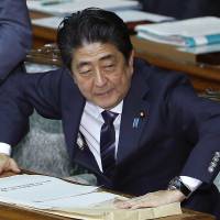Prime Minister Shinzo Abe prepares to speak in the Lower House of the Diet on Monday. Busy 2017 schedule fuels rumors of snap Lower House election in January