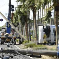 A truck lies on its side amid downed electricity poles after Typhoon Malakas pummeled Ibusuki, Kagoshima Prefecture, on Tuesday as it headed toward the Kanto region. Western, central Japan struck by powerful Typhoon Malakas