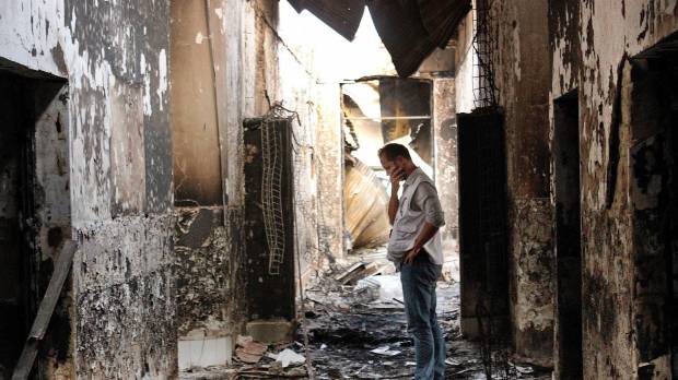 Hospitals as targets: An employee of Medecins Sans Frontieres walks inside the charred remains of the organization's hospital in Kunduz, Afghanistan, weeks after the building was hit by a U.S. airstrike on Oct. 3, 2015, killing 42 people. Medecins Sans Frontieres Japan calls for end to deadly attacks on hospitals
