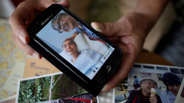 Survivor: Takashi Ono shows a recent photo of his wife, Chikiko, and stepson, Kazuya, a resident of the Tsukui Yamayuri En facility in Sagamihara. Kazuya is recovering from multiple stab wounds that left him in critical condition after the attack at the home for people with disabilities in July. Sagamihara massacre begs question: Do we want a society that only values usefulness?