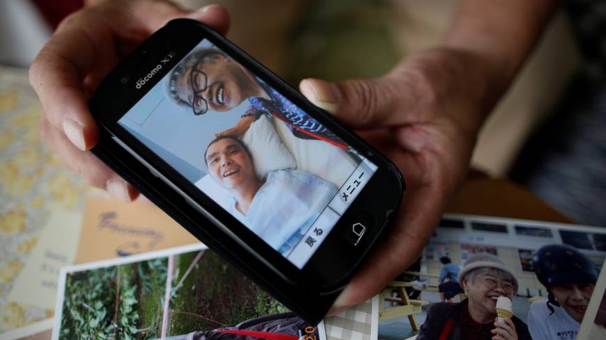 Survivor: Takashi Ono shows a recent photo of his wife, Chikiko, and stepson, Kazuya, a resident of the Tsukui Yamayuri En facility in Sagamihara. Kazuya is recovering from multiple stab wounds that left him in critical condition after the attack at the home for people with disabilities in July. Sagamihara massacre begs question: Do we want a society that only values usefulness?