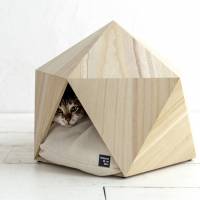The Hokura Paulownia pet box by Natural Slow Inc. has a small triangular opening, making it a cave-like space for cats and small dogs. The cat's meow of creature comforts