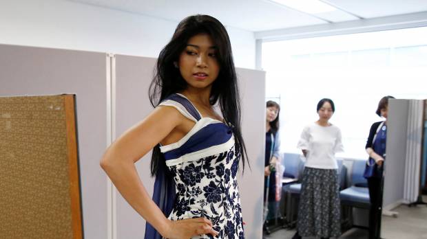 Turning heads, changing minds: Miss World Japan 2016 Priyanka Yoshikawa tries on a dress earlier this month in Tokyo as she chooses a costume to wear in the Miss World competition. Japan's beauty queens rewrite old rules on race and nationality