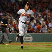 Baltimore's Jonathan Schoop rounds the bases after hitting a solo homer in the ninth inning of the Orioles' 6-3 win over the Red Sox on Tuesday. Orioles beat Red Sox to stay in hunt